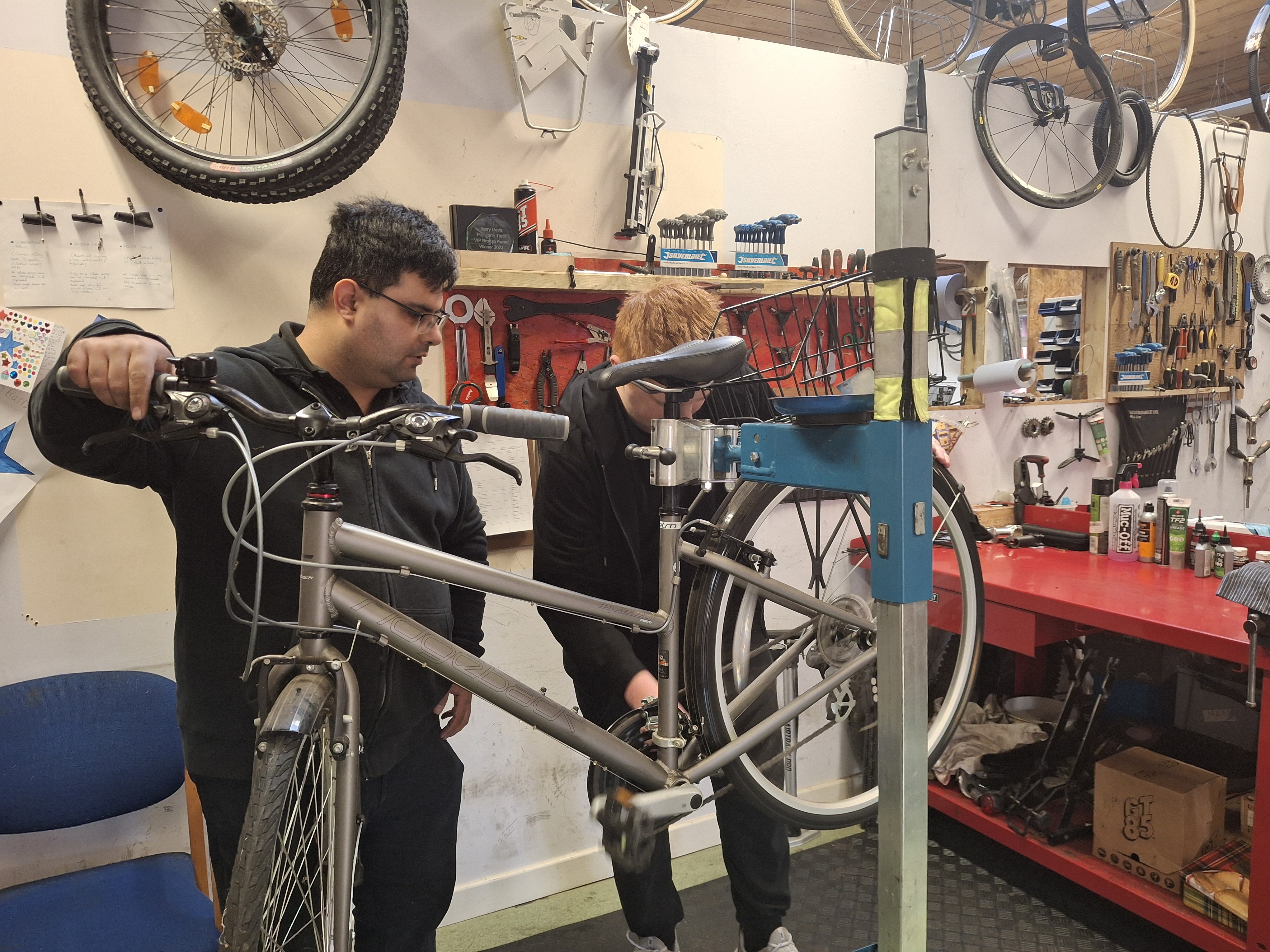 Imran and a customer working on a bike