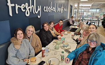 An image of some customers sitting around a dinner table