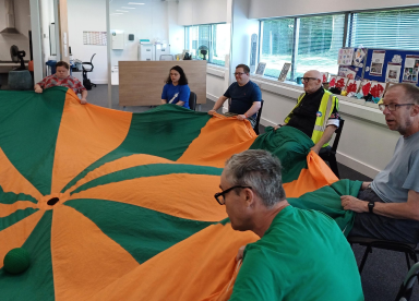 Customers playing a game of parachute
