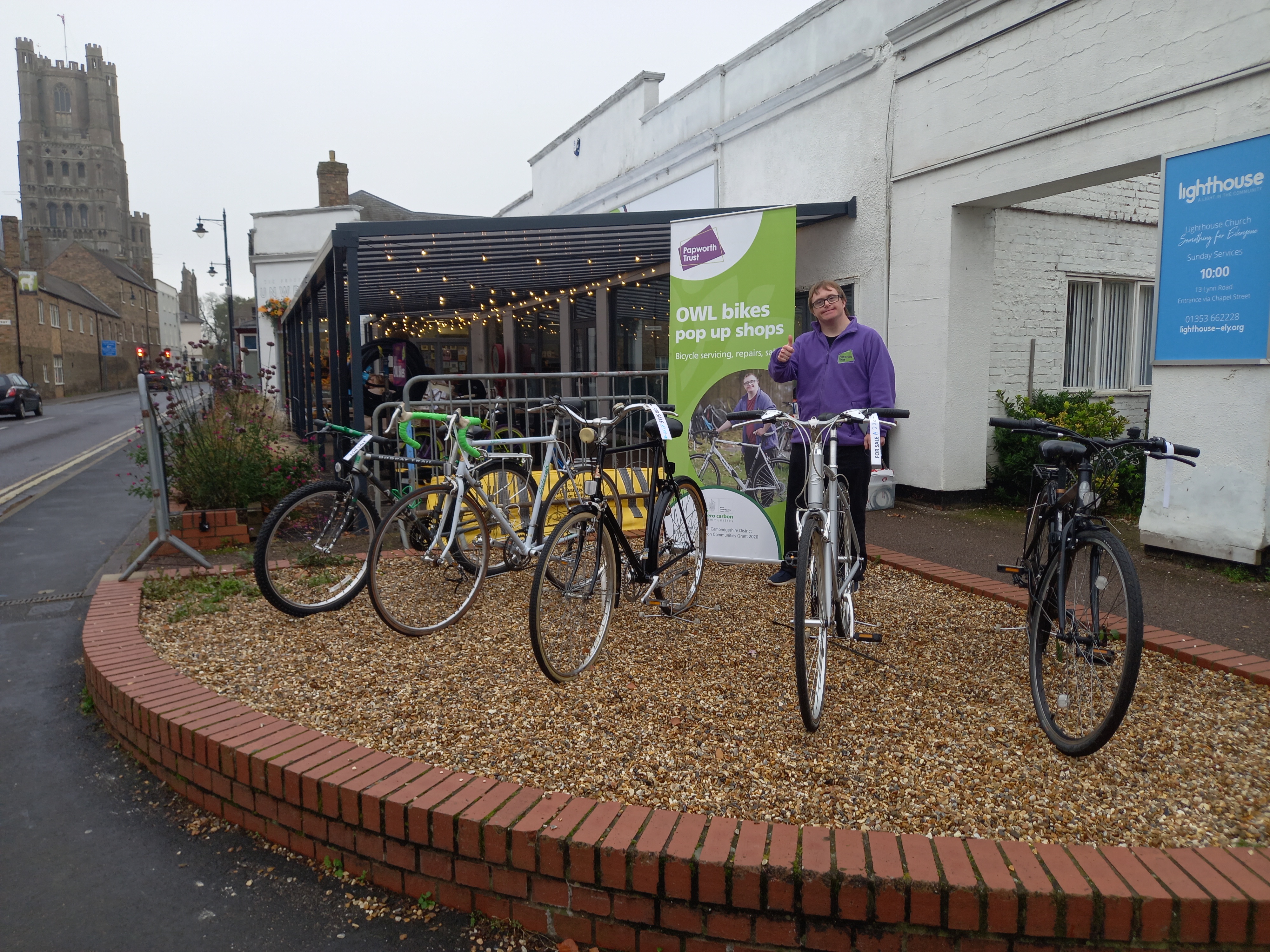 Picture of trainee Jack outside OWL bikes pop up shop