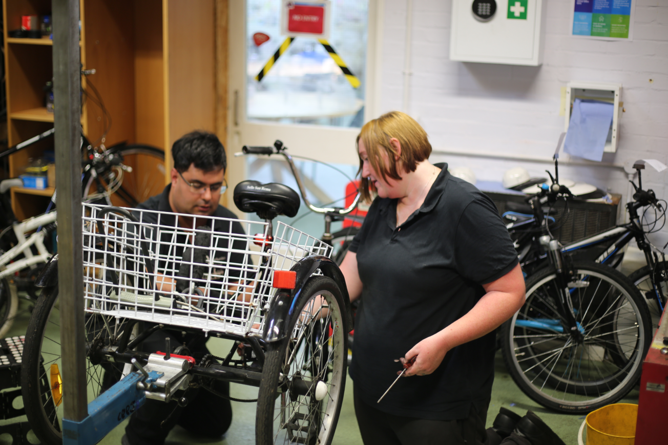 A photo of OWL Bikes volunteers working on a bike