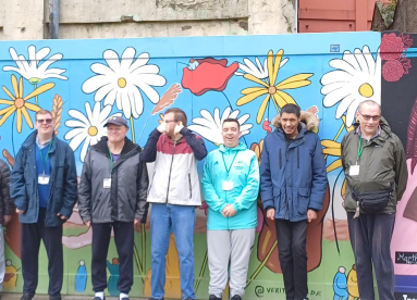 Customers in front of a mural