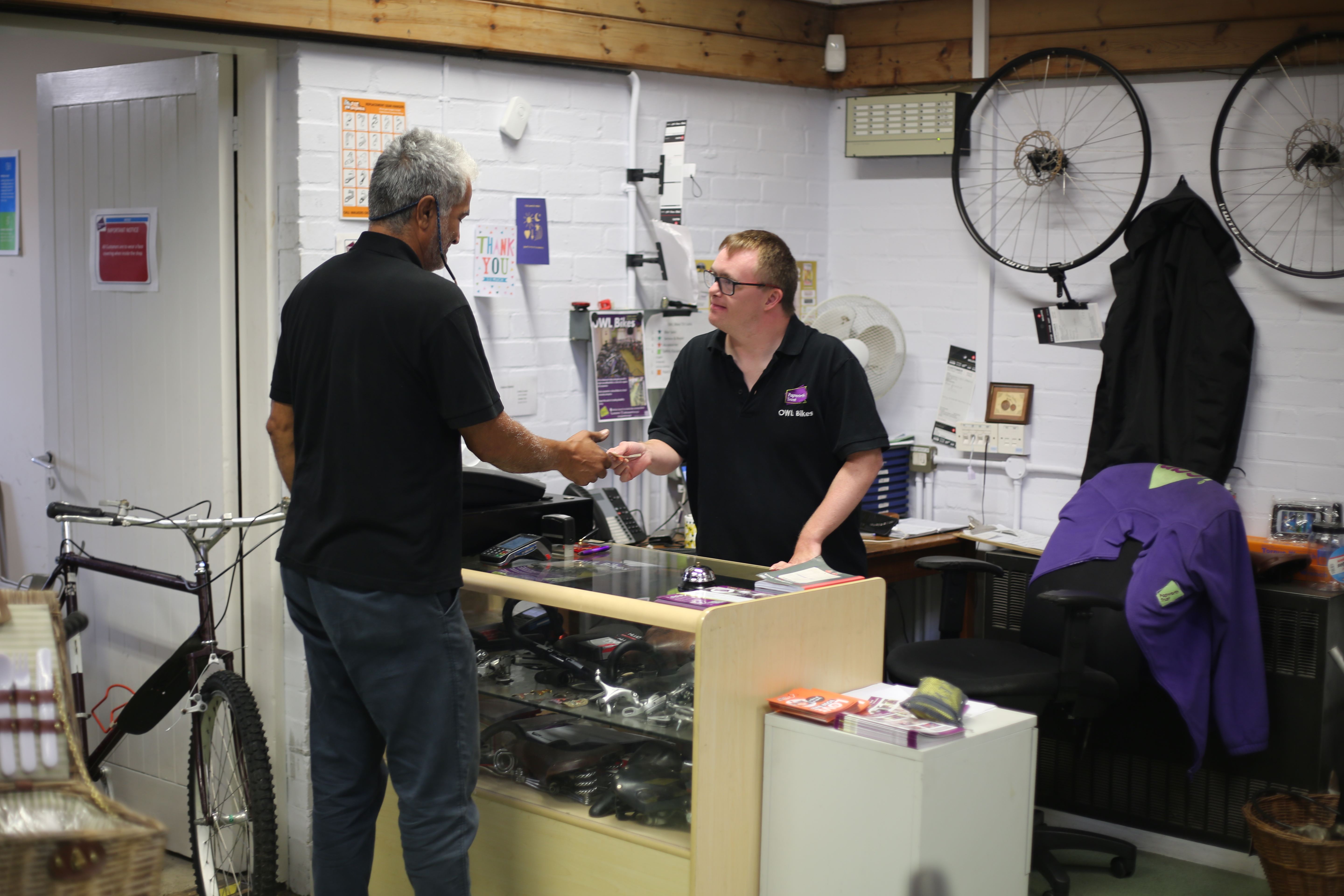 Photo of volunteer on the till